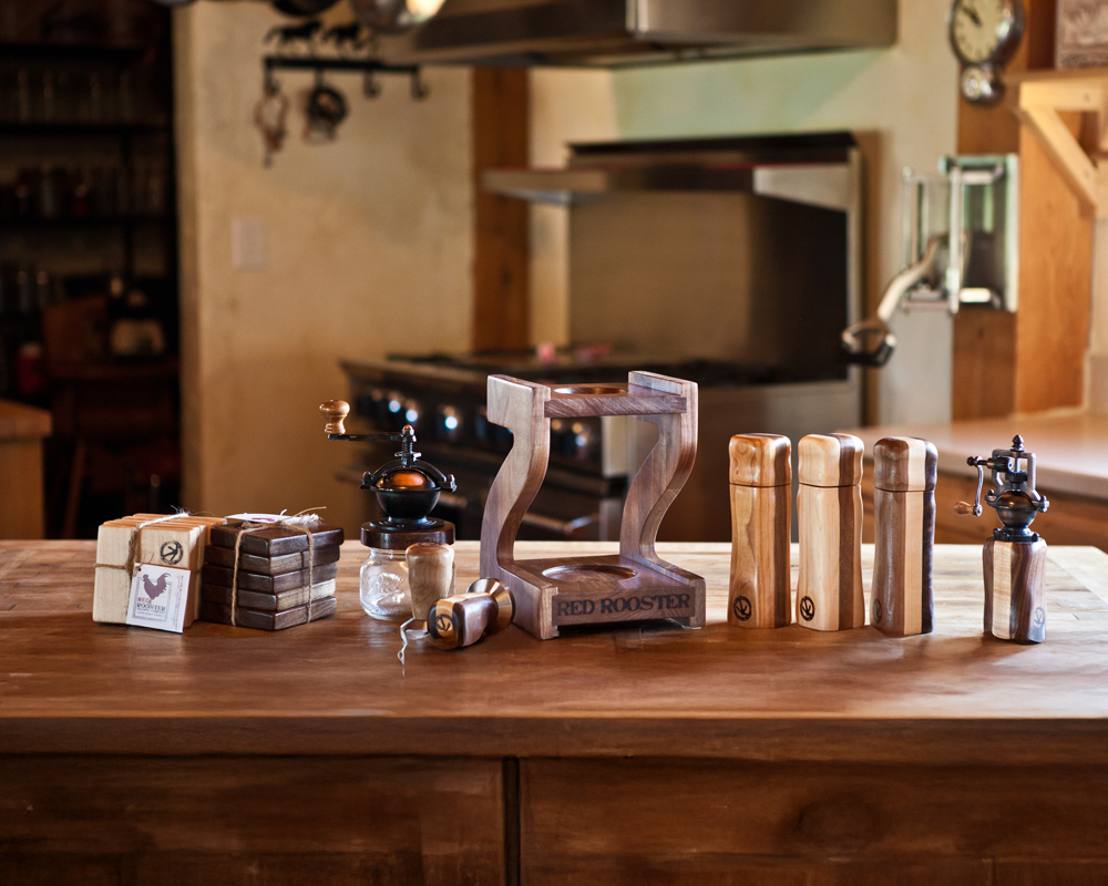 Red Rooster heritage goods lineup with Camano Coffee Mill manual coffee grinder, coffee drip stand, pepper mill, and espresso tampers